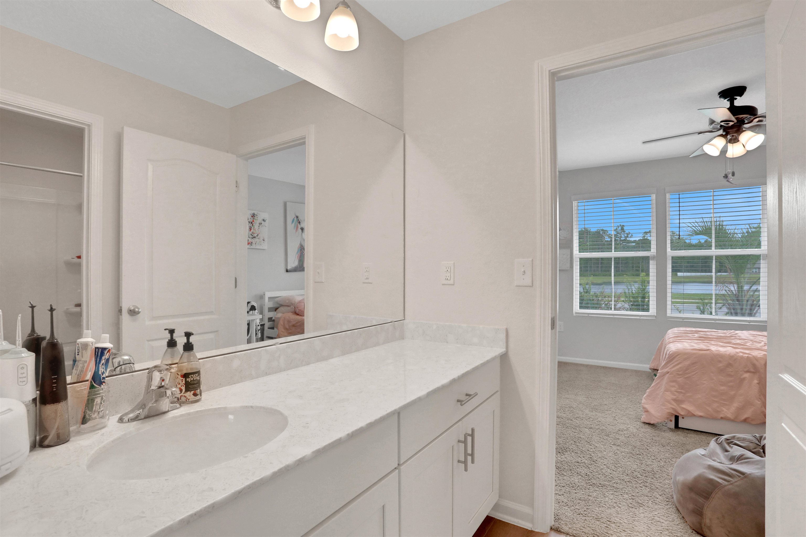 123 Hickory Ridge Road St. Augustine, FL 32084 - Photo 16 of 26 a bathroom with a double vanity sink a mirror and a bathtub