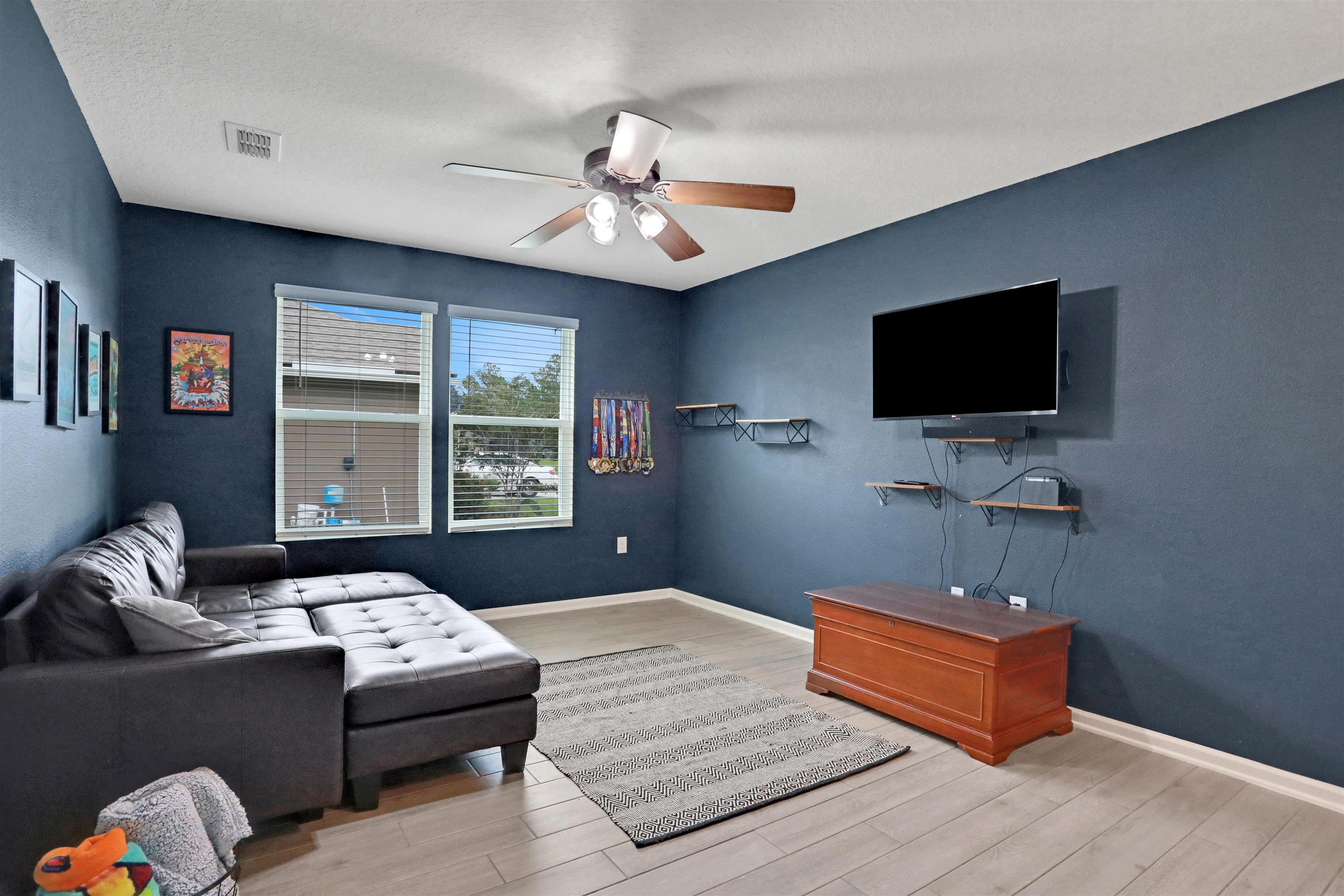 123 Hickory Ridge Road St. Augustine, FL 32084 - Photo 22 of 26 a bedroom with a bed and a flat screen tv