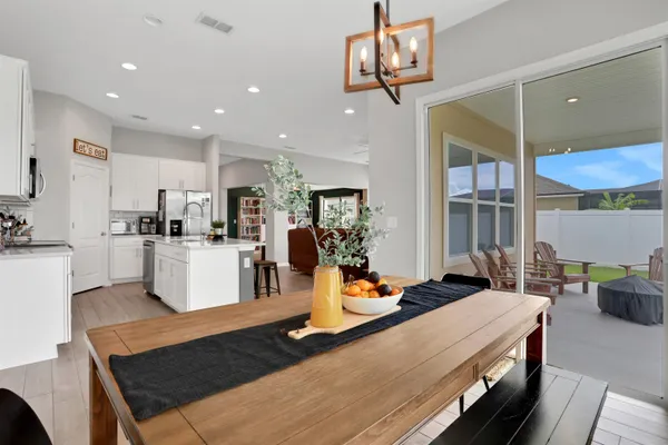 a kitchen with stainless steel appliances granite countertop a sink counter space and living room view