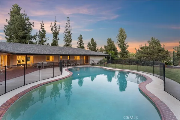 a view of a swimming pool with a yard