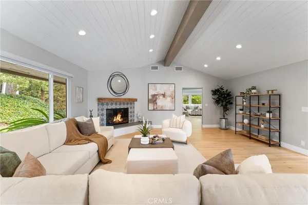 a living room with furniture a fireplace and a table
