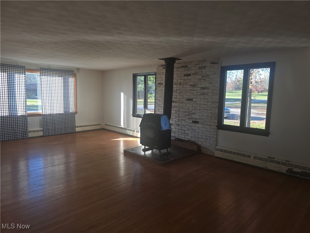 1254 Aberagg Road Atwater, OH 44201 - Photo 4 of 25 Great room with woodburning stove and hardwood floors
