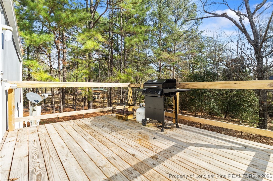 7321 Sheriff Watson Road Sanford, NC 27332 - Photo 23 of 26 a view of a chairs and table on the wooden deck