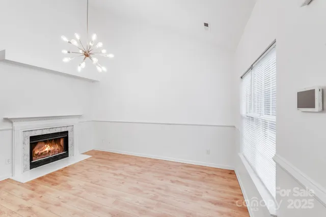 wooden floor in an empty room with a fireplace