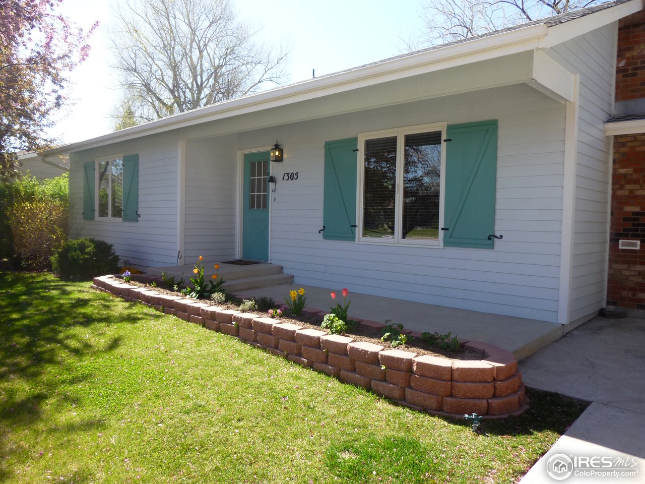 1305 Centennial Road Fort Collins, CO 80525 - Photo 3 of 25 Flower garden welcomes guests