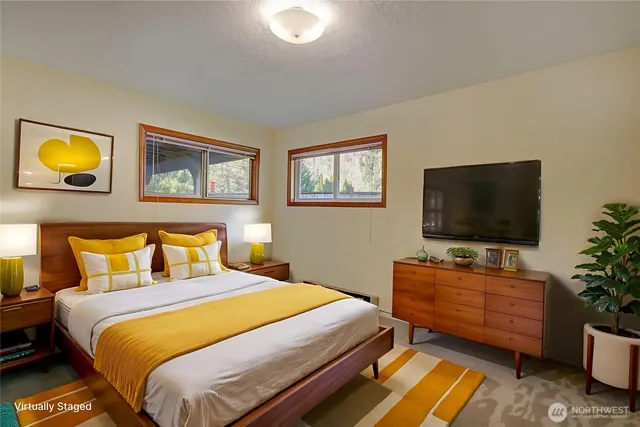 a bedroom with a bed and a flat screen tv