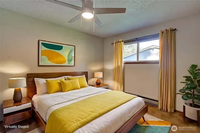 a bedroom with a bed and a potted plant