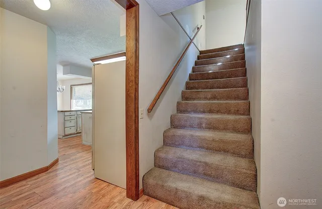 a view of entryway and hall with wooden floor