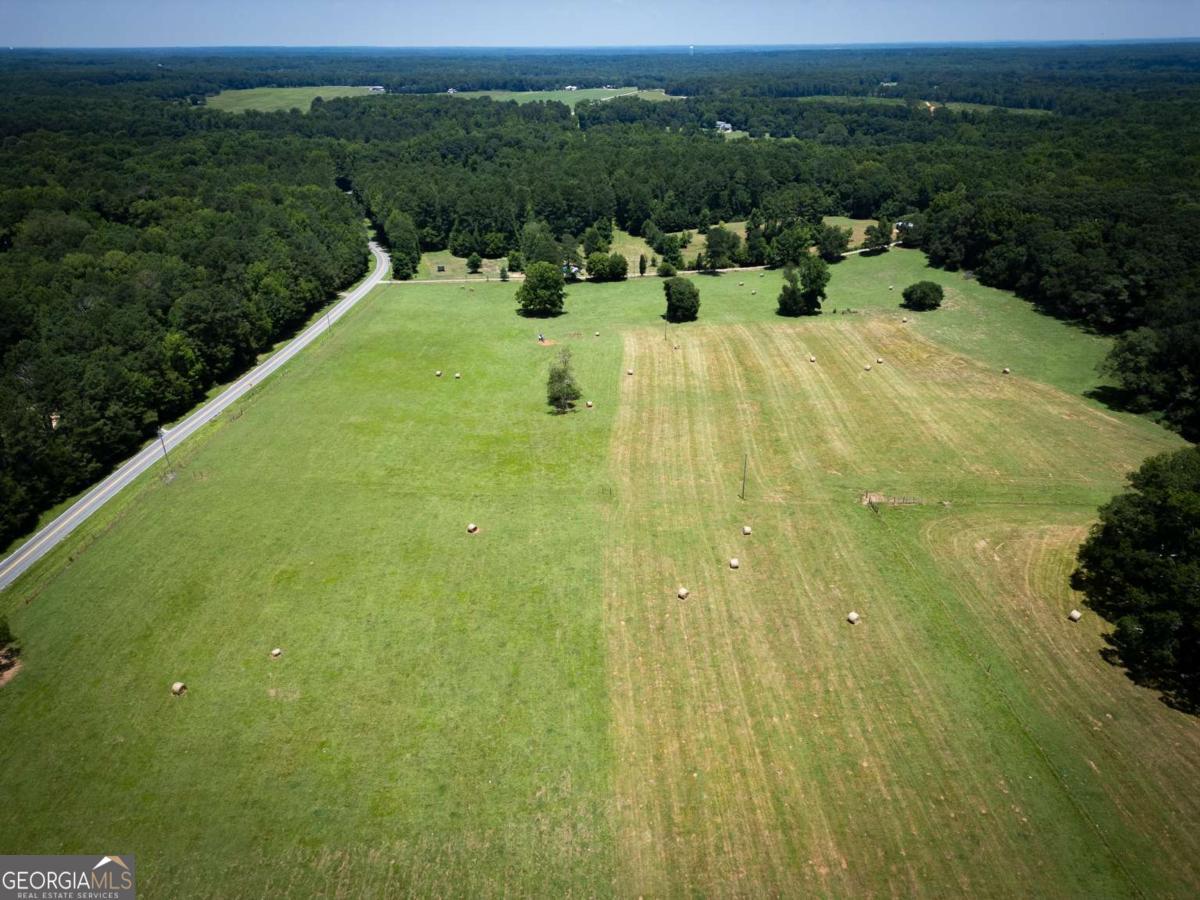0 Charlie Bolton Road Winterville, GA 30683 - Photo 16 of 20 a view of a swimming pool with an outdoor space and seating area