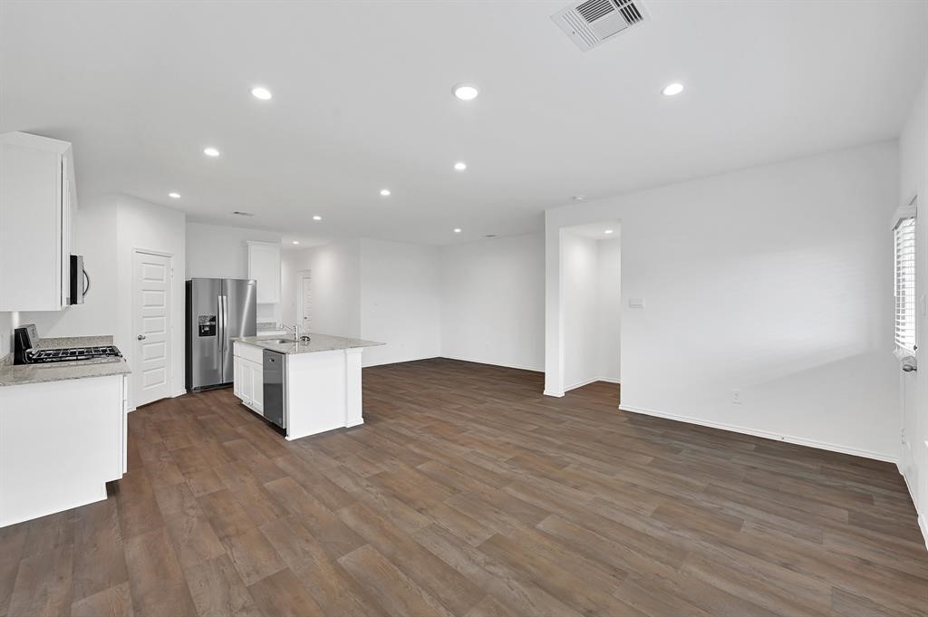 31006 Brightwell Bend Fulshear, TX 77441 - Photo 11 of 47 a view of kitchen with kitchen island wooden cabinets and stainless steel appliances
