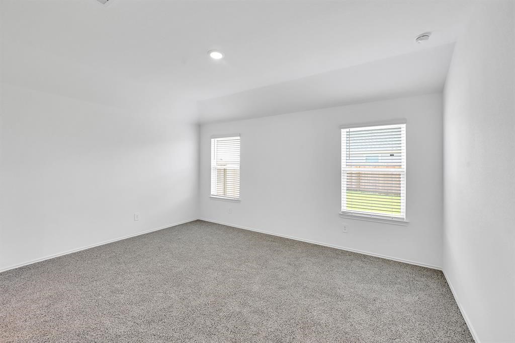 31006 Brightwell Bend Fulshear, TX 77441 - Photo 12 of 47 an empty room with windows