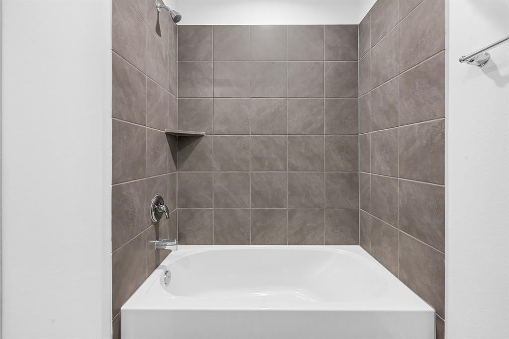 31006 Brightwell Bend Fulshear, TX 77441 - Photo 20 of 47 a close up of a bathtub in a bathroom