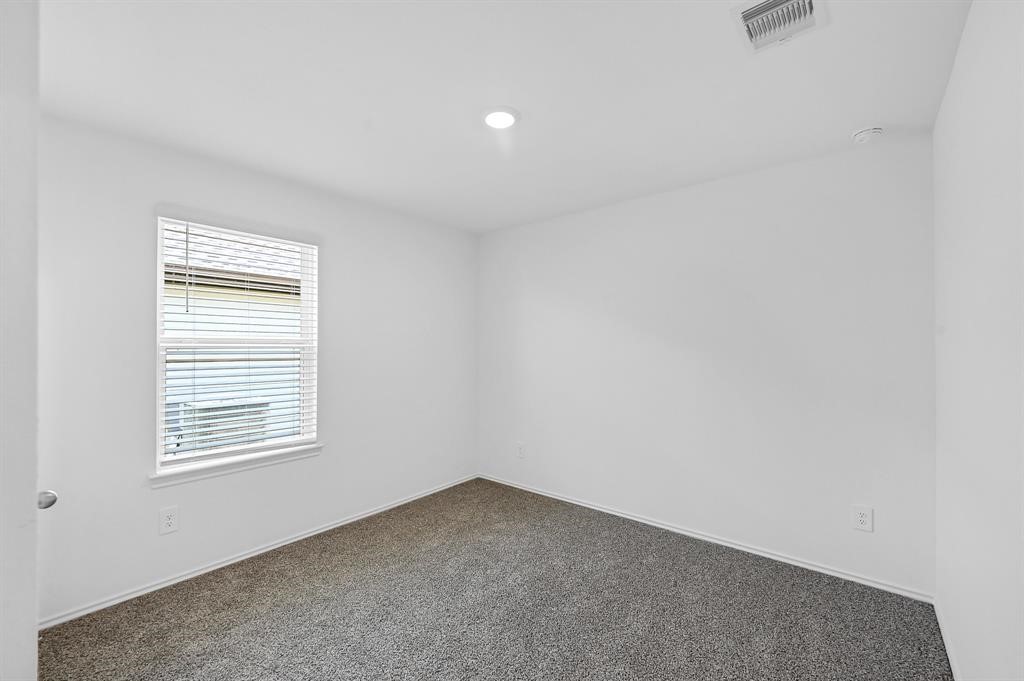 31006 Brightwell Bend Fulshear, TX 77441 - Photo 23 of 47 an empty room with windows
