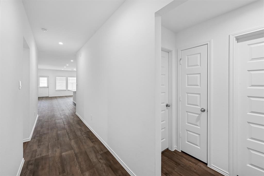 31006 Brightwell Bend Fulshear, TX 77441 - Photo 24 of 47 a view of a hallway with wooden floor