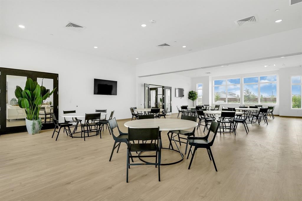 31006 Brightwell Bend Fulshear, TX 77441 - Photo 39 of 47 a view of a dining room with furniture window and wooden floor