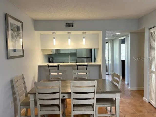 a view of kitchen with stainless steel appliances kitchen island