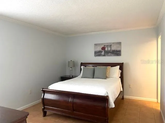 a bed sitting in a bedroom next to a small yard