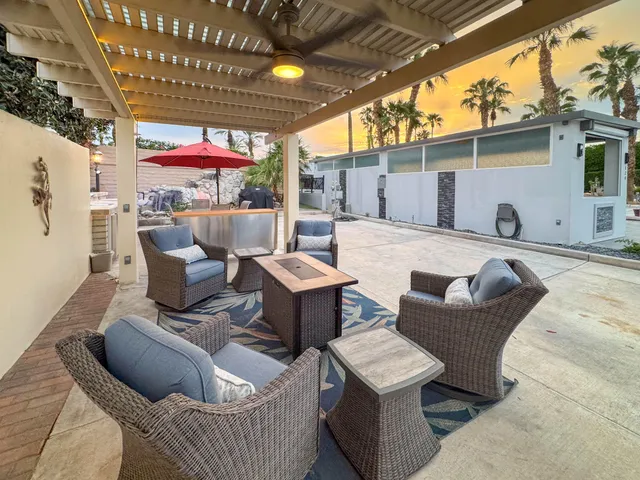 a outdoor living space with patio furniture and a fireplace