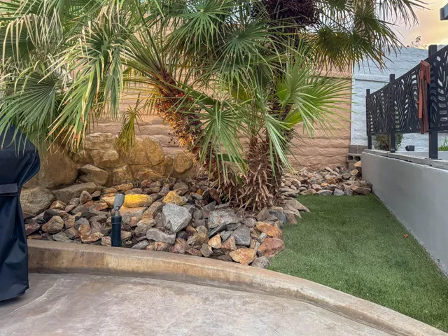 front view of a house with a yard and potted plants