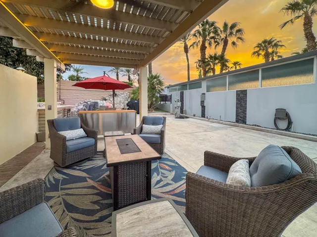 an outdoor space with pool and furniture