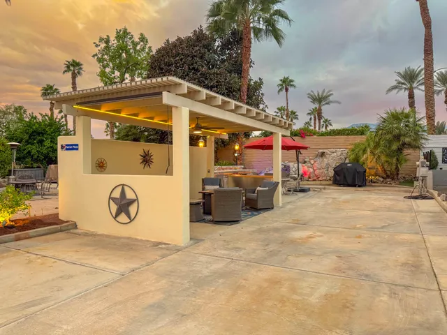 a building outdoor space with patio furniture and potted plants