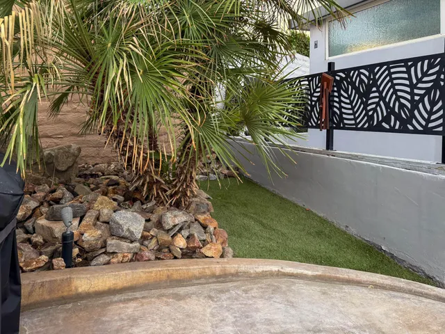 a view of a street with potted plants