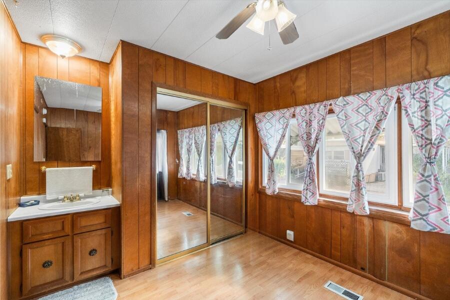 481 Twin View Boulevard, Unit 63 Redding, CA 96003 - Photo 15 of 20 a bathroom with a double vanity sink and mirror with bathtub