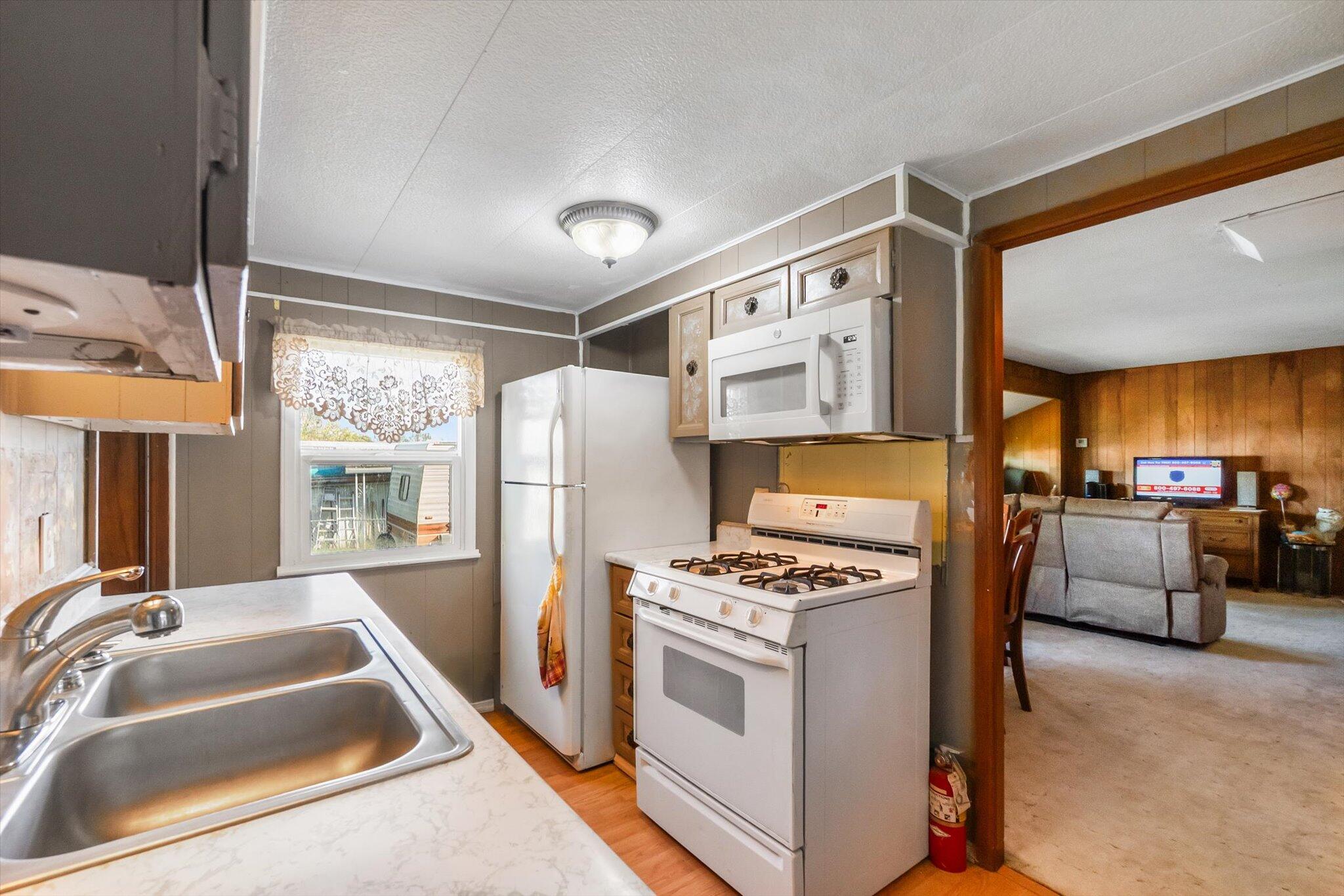 481 Twin View Boulevard, Unit 63 Redding, CA 96003 - Photo 8 of 20 a kitchen that has a lot of cabinets a sink and a refrigerator