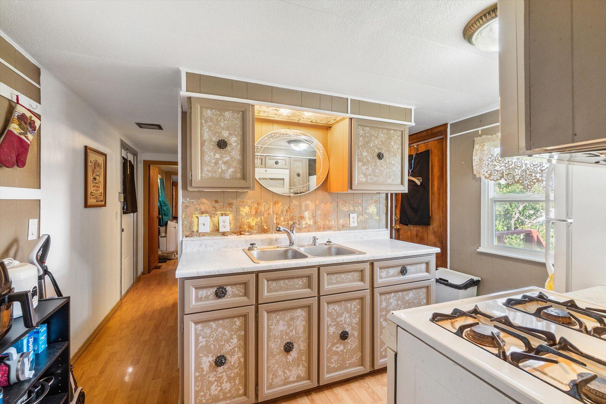 481 Twin View Boulevard, Unit 63 Redding, CA 96003 - Photo 9 of 20 a kitchen with a sink stove and cabinets