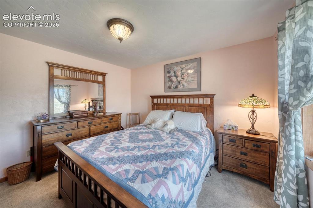 489 Excelsior Road Westcliffe, CO 81252 - Photo 16 of 34 a bedroom with a bed and a dresser in it