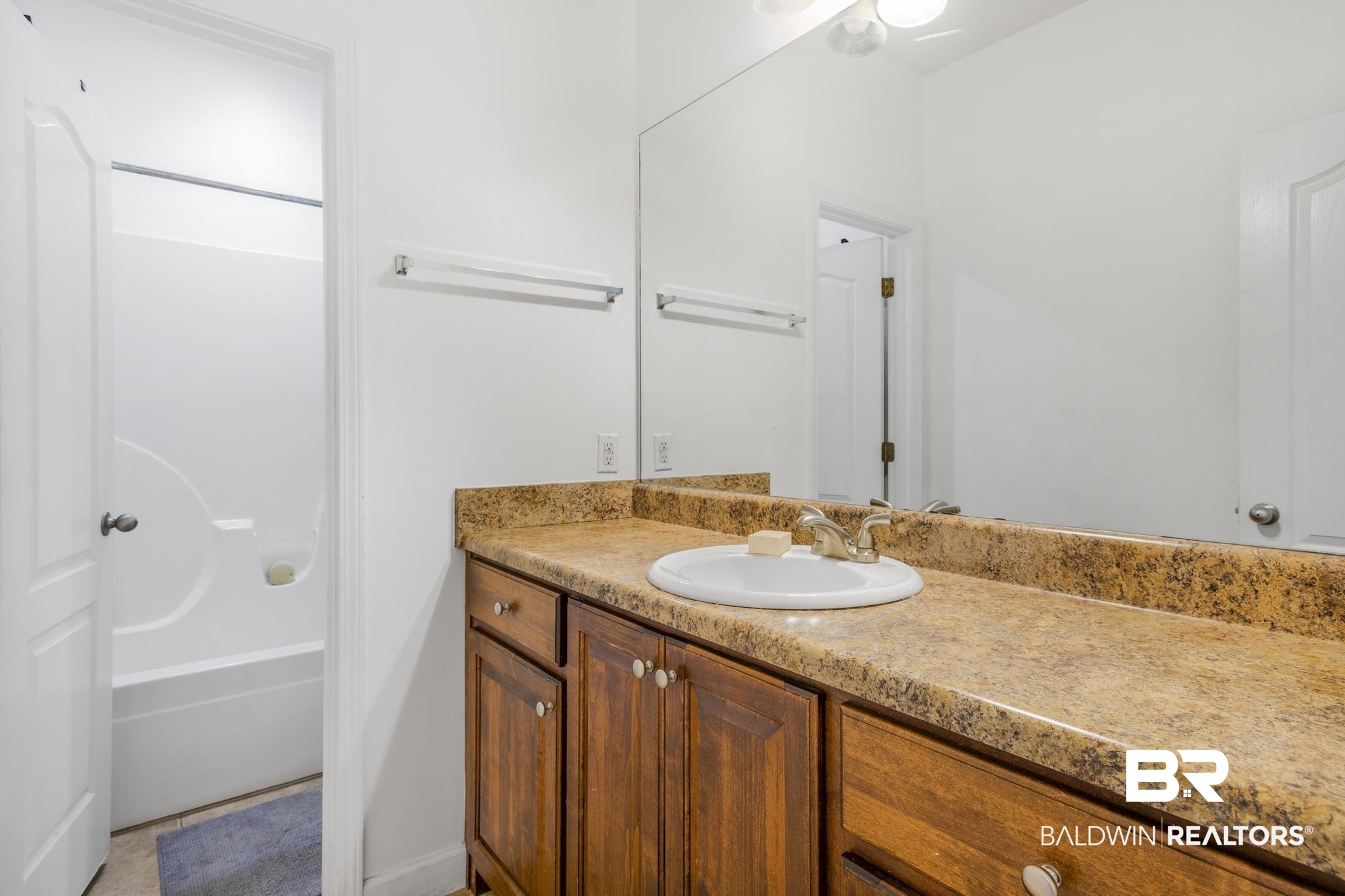 35814 Delvan Lane Bay Minette, AL 36507 - Photo 29 of 53 Bathroom vanity featuring a granite-style countertop, undermount sink, and wood-finish cabinetry