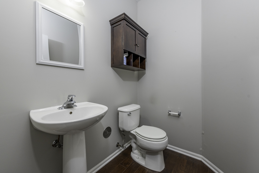 2879 Falling Waters Drive, Unit 2879 Lindenhurst, IL 60046 - Photo 11 of 30 a bathroom with a toilet sink and mirror