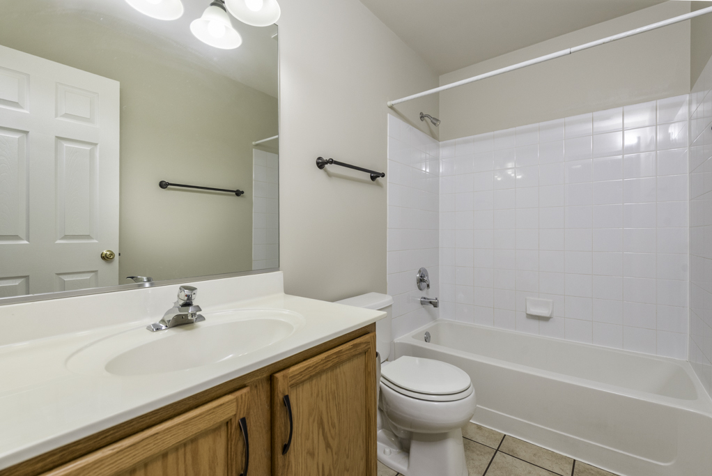 2879 Falling Waters Drive, Unit 2879 Lindenhurst, IL 60046 - Photo 12 of 30 a bathroom with a sink a toilet and shower