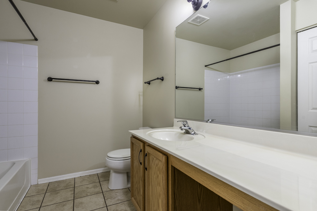 2879 Falling Waters Drive, Unit 2879 Lindenhurst, IL 60046 - Photo 14 of 30 a bathroom with a sink a toilet and shower