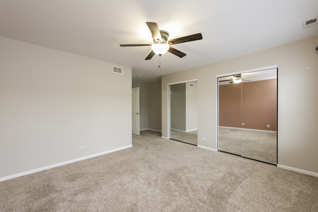 2879 Falling Waters Drive, Unit 2879 Lindenhurst, IL 60046 - Photo 17 of 30 wooden floor in an empty room