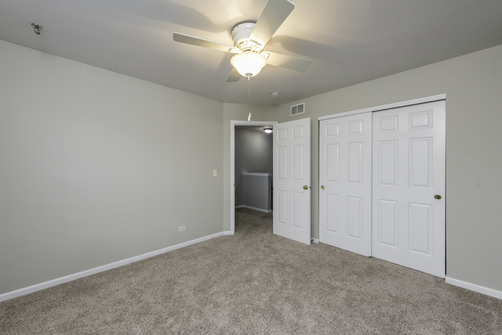 2879 Falling Waters Drive, Unit 2879 Lindenhurst, IL 60046 - Photo 20 of 30 a view of an empty room and a ceiling fan