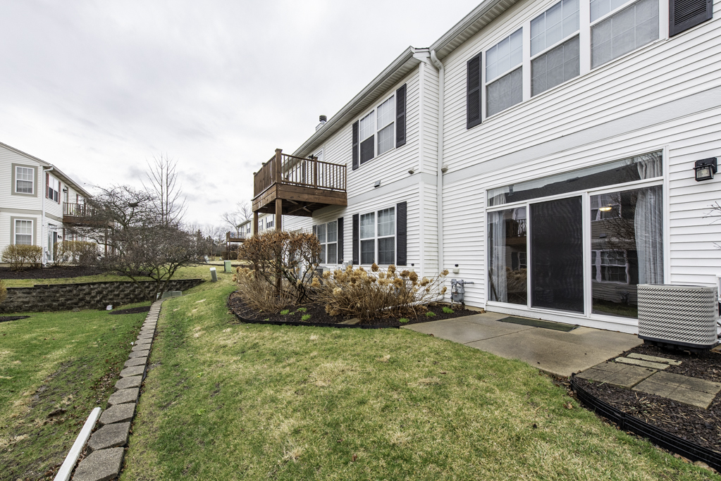 2879 Falling Waters Drive, Unit 2879 Lindenhurst, IL 60046 - Photo 21 of 30 a front view of a house with garden
