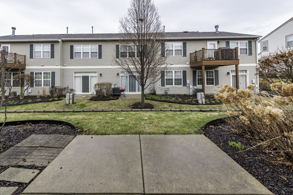 2879 Falling Waters Drive, Unit 2879 Lindenhurst, IL 60046 - Photo 24 of 30 a front view of a house with a yard