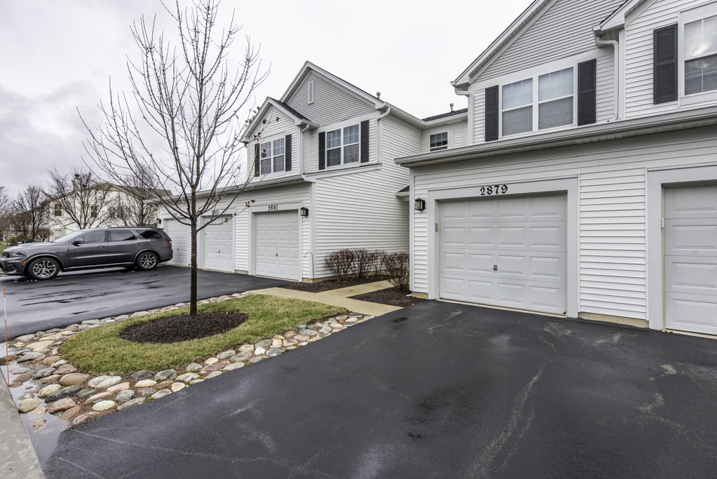 2879 Falling Waters Drive, Unit 2879 Lindenhurst, IL 60046 - Photo 25 of 30 a front view of a house with a yard