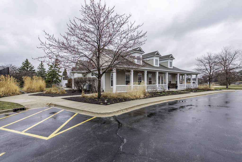 2879 Falling Waters Drive, Unit 2879 Lindenhurst, IL 60046 - Photo 26 of 30 a view of a white house with a large windows next to a road