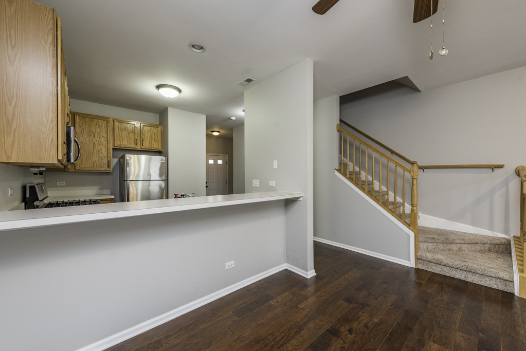 2879 Falling Waters Drive, Unit 2879 Lindenhurst, IL 60046 - Photo 7 of 30 a view of kitchen with wooden floor and electronic appliances
