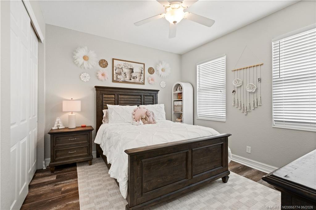 1268 Southeast Kirk Street Stuart, FL 34997 - Photo 44 of 63 a bedroom with a bed and a chandelier