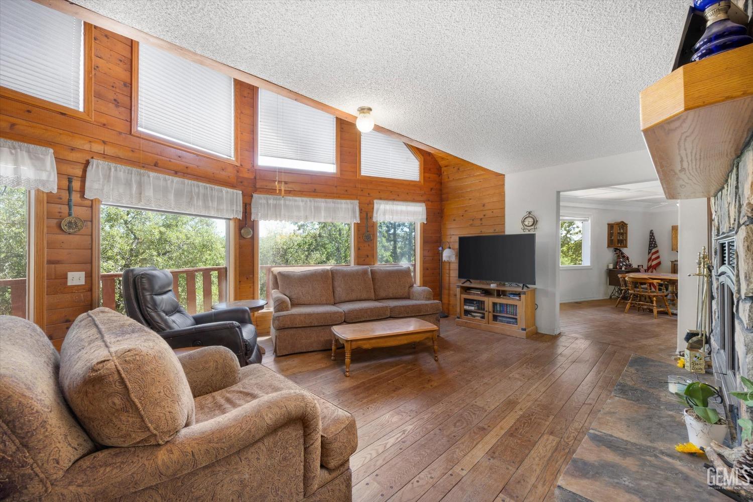 Undisclosed Address Tehachapi, CA 93561 - Photo 6 of 16 a living room with furniture a large window and a flat screen tv
