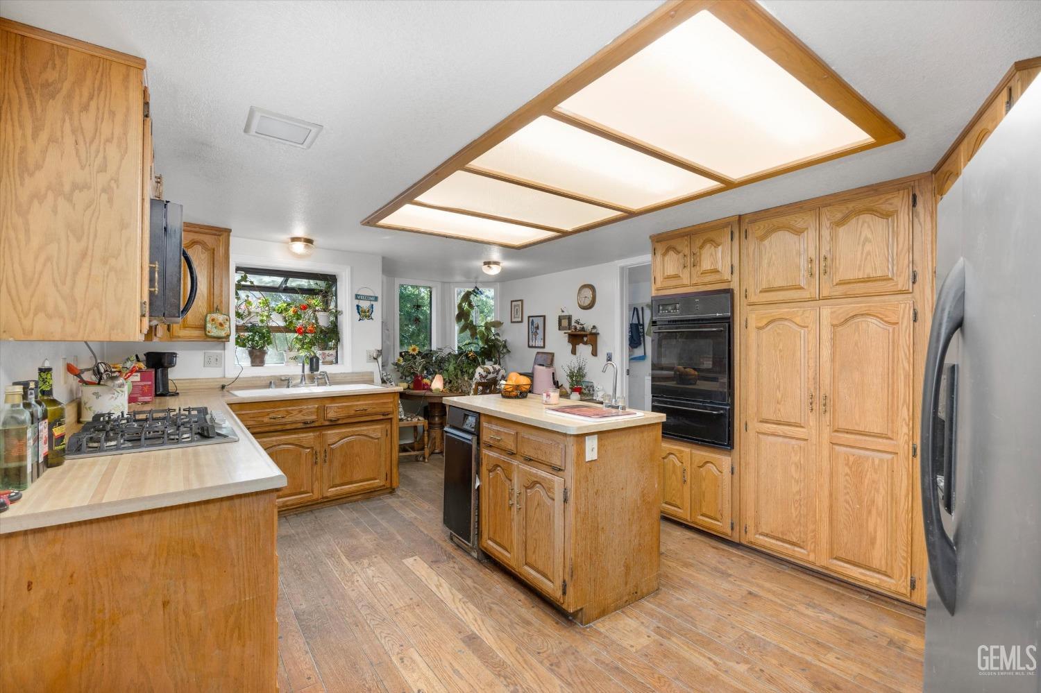 Undisclosed Address Tehachapi, CA 93561 - Photo 10 of 16 a kitchen with a sink stove and refrigerator