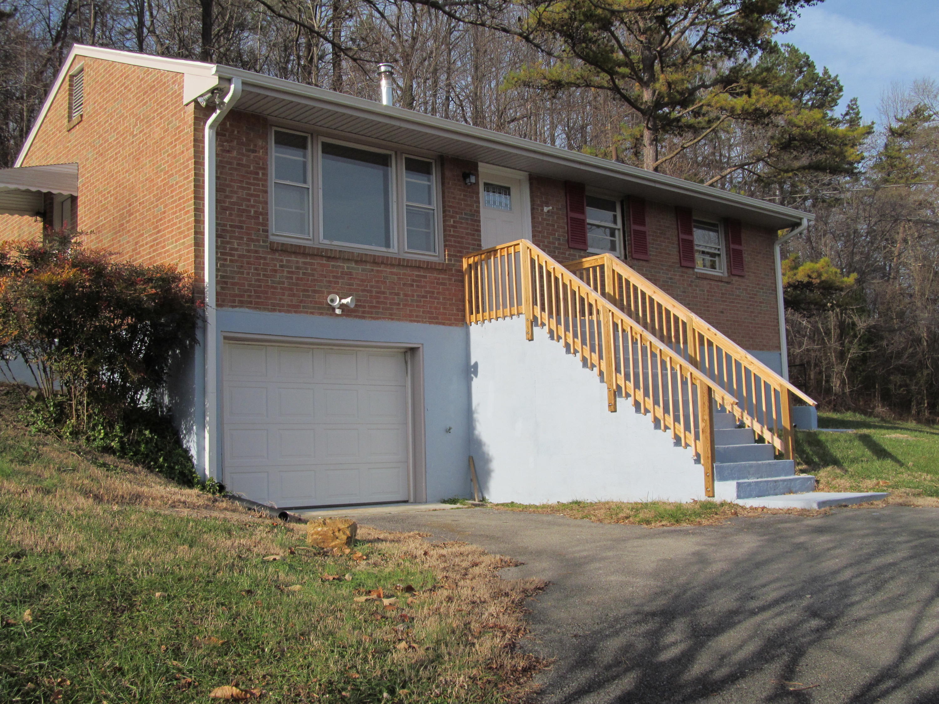 a view of a house with garage and wooden fence