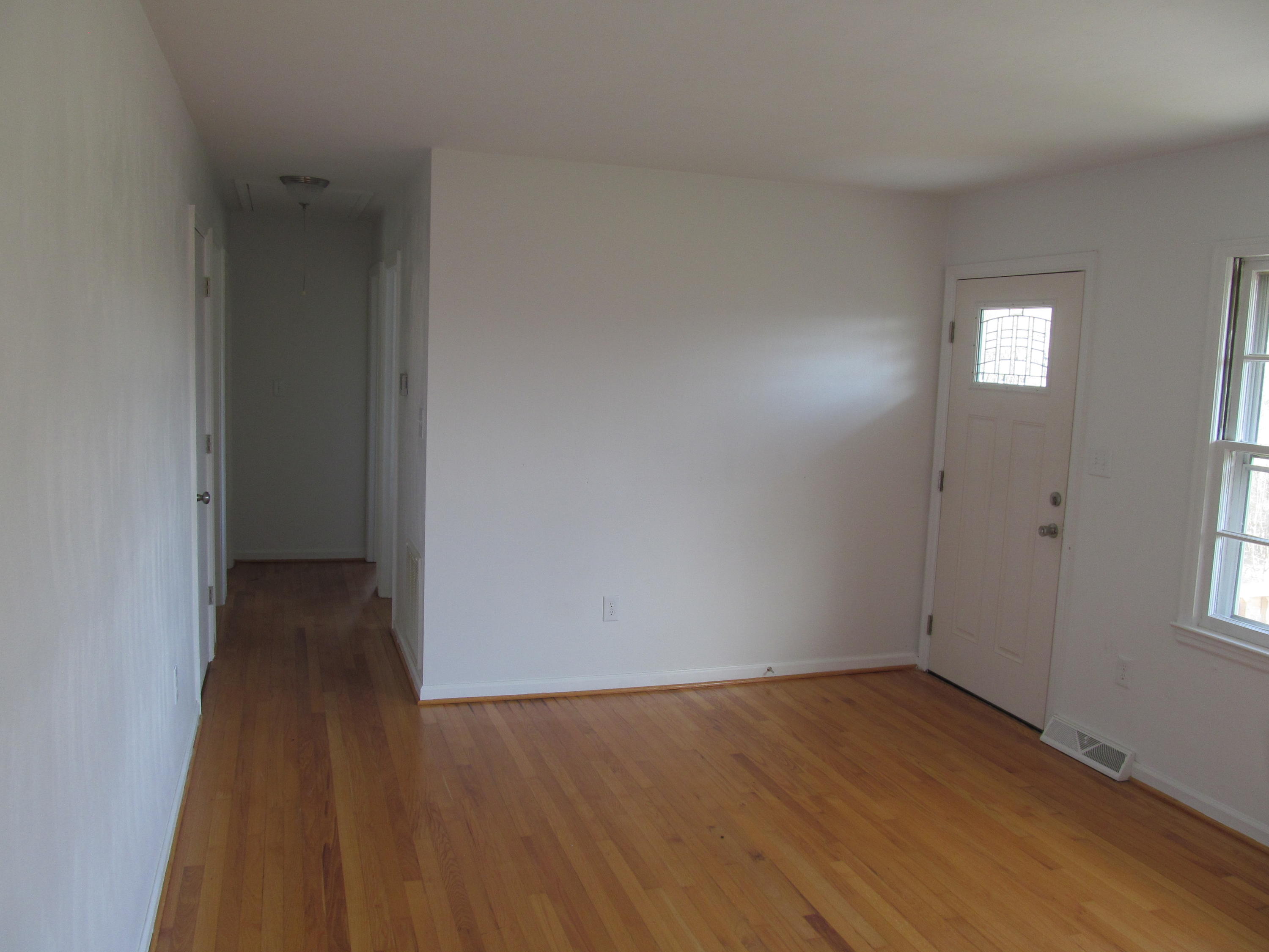 1370 Blue Ridge Springs Road Blue Ridge, VA 24064 - Photo 2 of 20 an empty room with wooden floor and windows