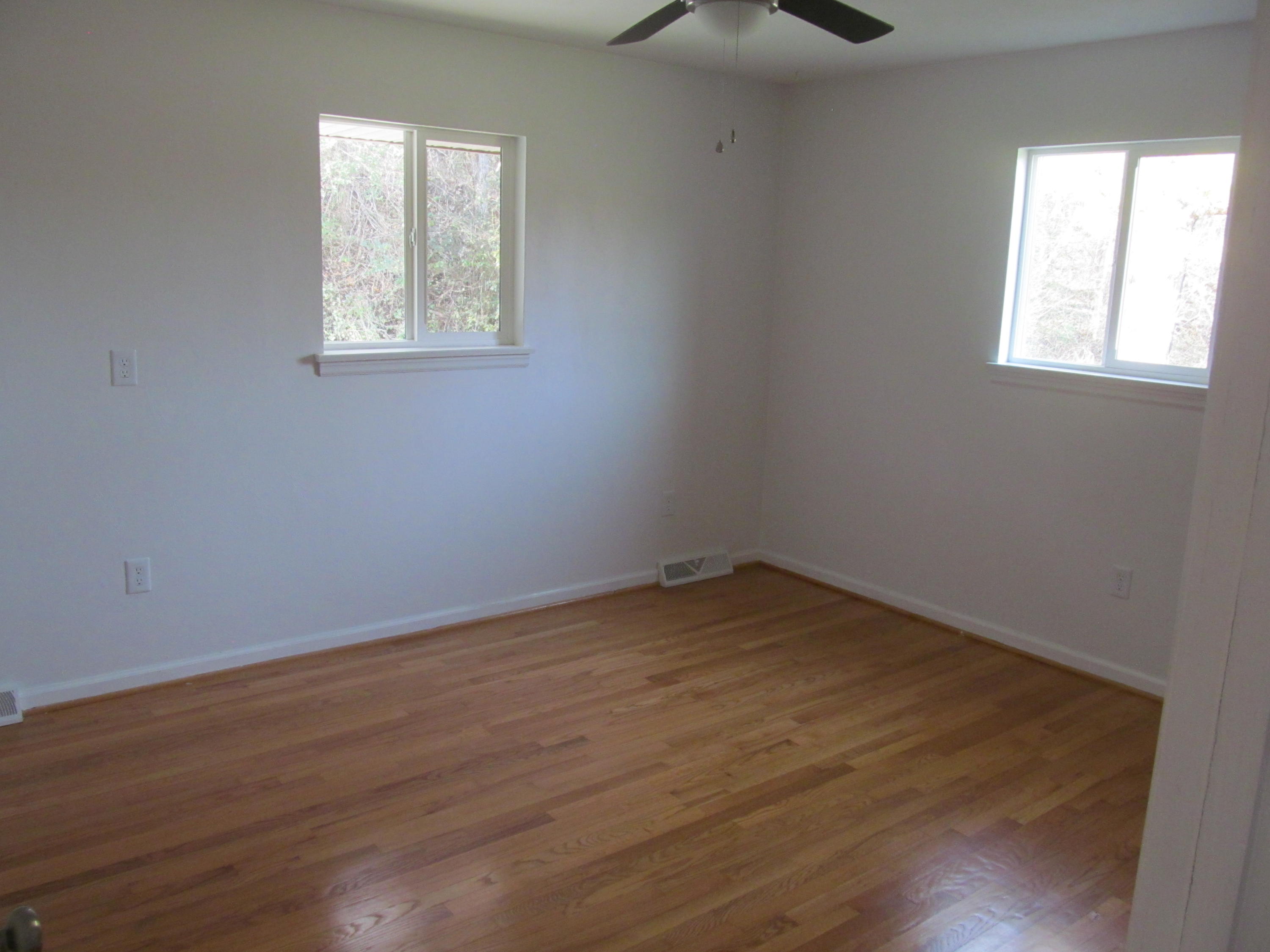 1370 Blue Ridge Springs Road Blue Ridge, VA 24064 - Photo 7 of 20 an empty room with wooden floor and windows