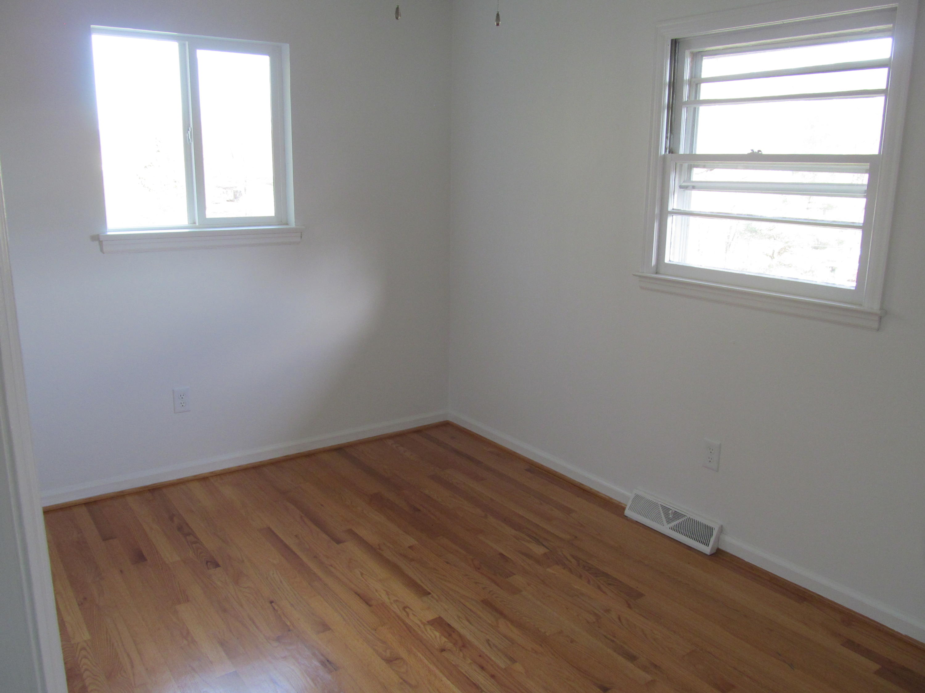 1370 Blue Ridge Springs Road Blue Ridge, VA 24064 - Photo 8 of 20 an empty room with wooden floor and windows