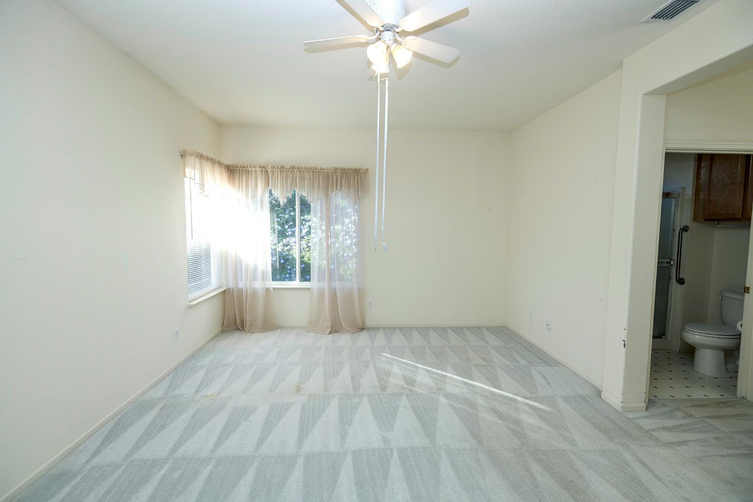 2123 Spring Blossom Lane Turlock, CA 95382 - Photo 15 of 44 a view of a room with a window and a ceiling fan