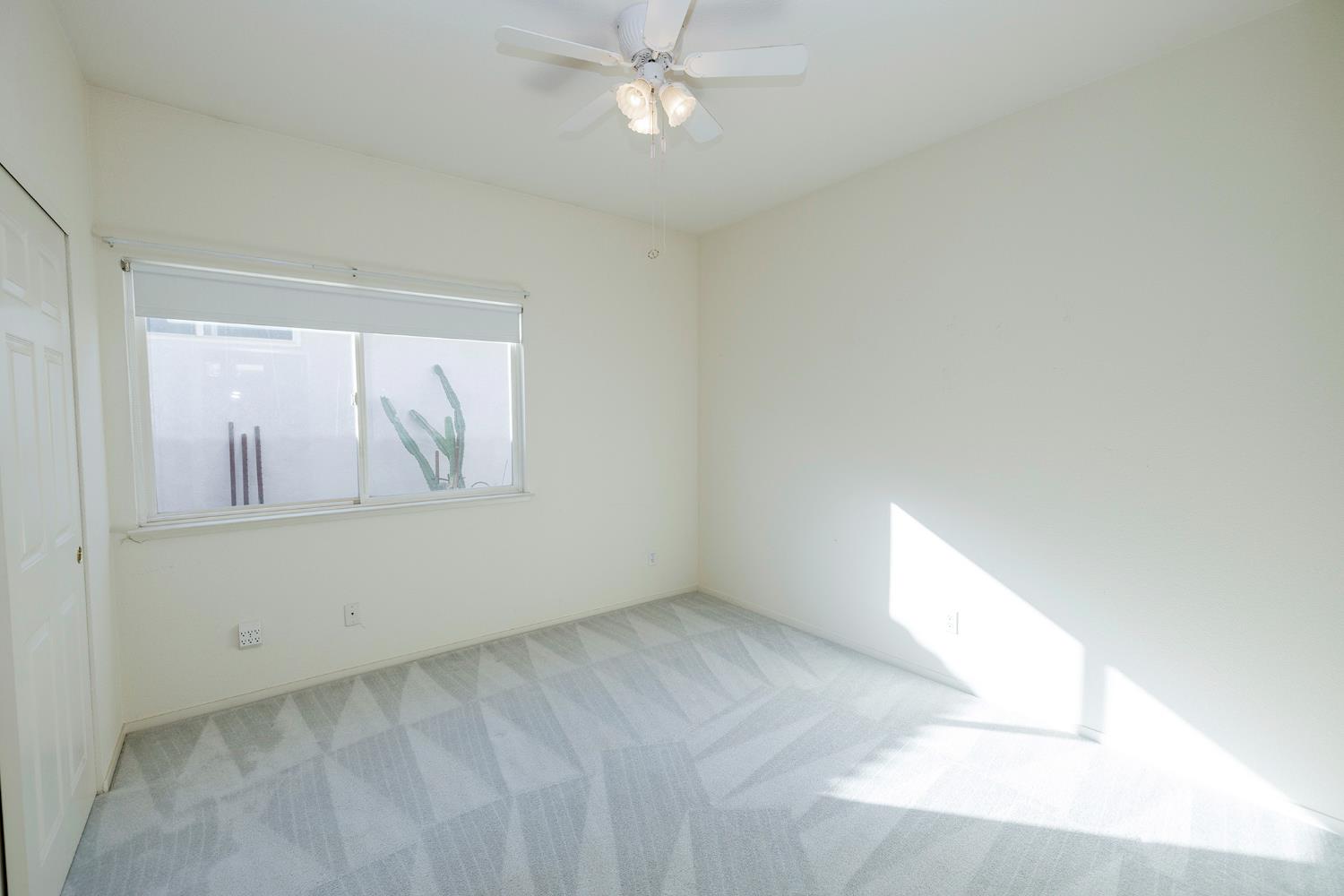 2123 Spring Blossom Lane Turlock, CA 95382 - Photo 20 of 44 an empty room with windows and fan